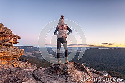 Bushwalker on summit of mountain with valley views Stock Photo