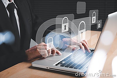 Businesman hand using computer with padlock security interface to protect data Stock Photo