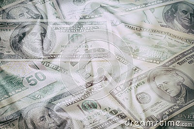 Business abstract background - banknotes of dollars close-up, scattered on wrinkled fabric Stock Photo