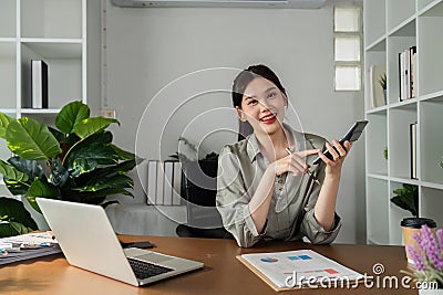 business accountant using calculator to calculate money in company report and looking at the camera Stock Photo