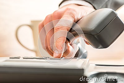 Business adviser dialing out on a land line telephone Stock Photo