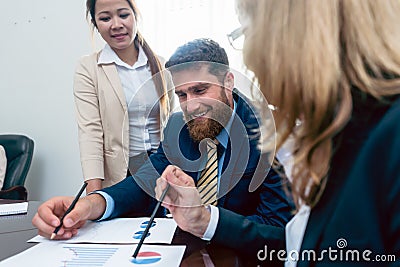 Business analyst smiling while interpreting financial reports sh Stock Photo