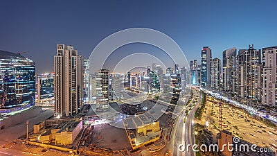 Business Bay with modern towers residential development aerial panoramic day to night timelapse, Dubai Editorial Stock Photo