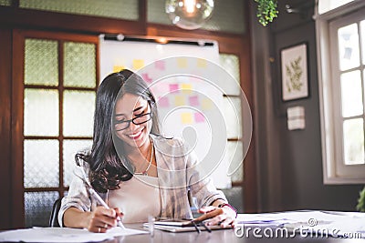 Business beautiful Asian woman working and writing note Stock Photo