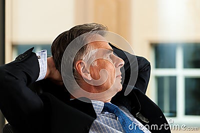 Business - Boss contemplating in his office Stock Photo