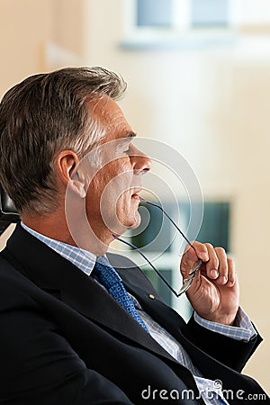 Business - Boss contemplating in his office Stock Photo