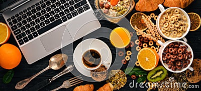 Business breakfast, muesli, coffee, milk, fruits, nuts and seeds, on a wooden surface. Top view. Stock Photo