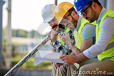 Business building teamwork people concept. Group of engineer with blueprint on construction site Stock Photo