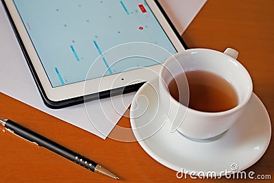 Business, calendars, appointment. Office table with notepad, computer, coffee cup. Stock Photo