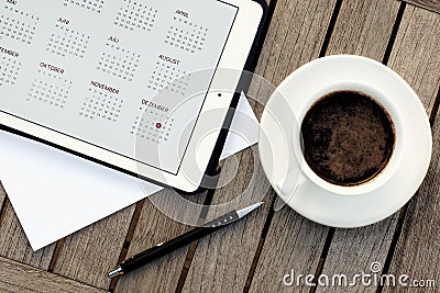 Business, calendars, appointment. Office table with notepad, computer, coffee cup. Stock Photo