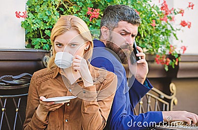 Business call white dating. First meet of girl and mature man. Brutal bearded hipster and girl drink coffee. Couple in Stock Photo