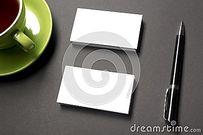 Business card blank over coffee cup and pen at office table. Corporate stationery branding mock-up Stock Photo