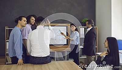 Business coach or team manager making presentation while training group of workers Stock Photo