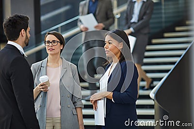 Business colleagues discussing project plan in lobby Stock Photo