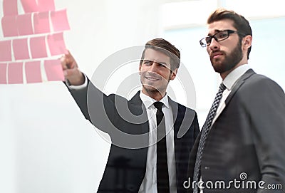Business colleagues discussing stickers-notes on the office Board Stock Photo