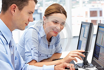 Business Colleagues helping each other on computer Stock Photo