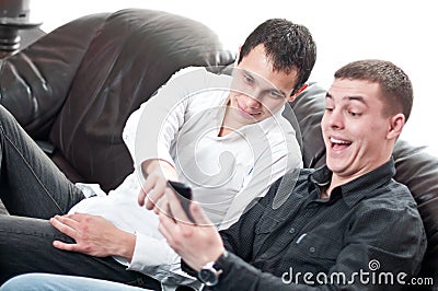 Business colleagues reading funny message Stock Photo