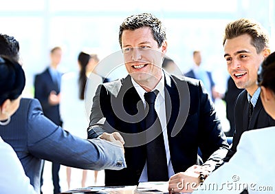 Business colleagues sitting at a table during a meeting with two mal Stock Photo