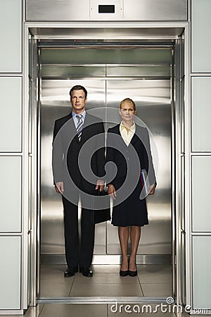Business Colleagues Standing Together In Elevator Stock Photo