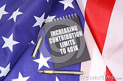 On the American flag lies a pen and a notebook with the inscription - increasing contribution limits to 401k Stock Photo