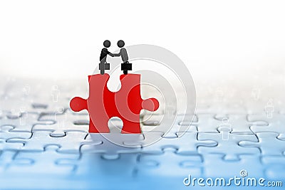Business concept background with two businessman handshake icon on red jigsaw with people connection in background Stock Photo