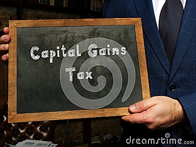 Business concept about Capital Gains Tax with sign on the black chalkboard Stock Photo