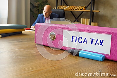 Business concept about FICA TAX Federal Insurance Contributions Act with phrase on the File Folder Stock Photo