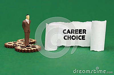 The figure of a man stands on the gears and reads the inscription - CAREER CHOICE on paper Stock Photo