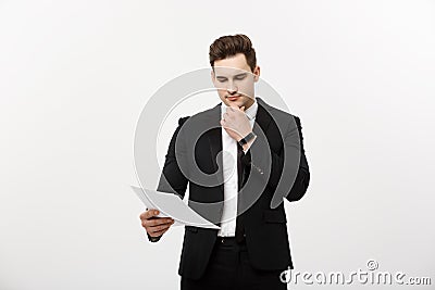 Business Concept: Focused handsome businessman thinking of annually business report ,revenue or document Stock Photo