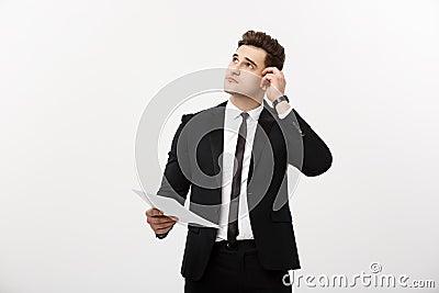 Business Concept: Focused handsome businessman thinking of annually business report ,revenue or document Stock Photo