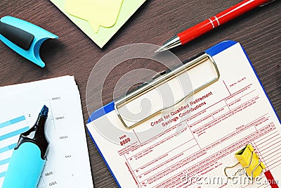 Business concept about Form 8880 Credit for Qualified Retirement Savings Contributions with sign on the sheet Stock Photo