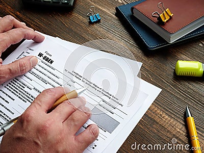 Business concept about Form W-8BEN Certificate of Foreign Status of Beneficial Owner for United States Tax Withholding and Editorial Stock Photo