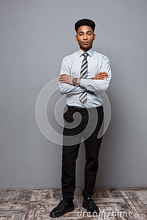 Business Concept - Full length portrait of confident african american businessman in the office. Stock Photo