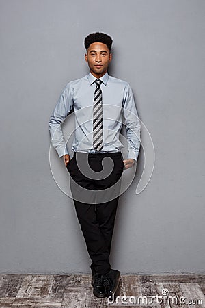 Business Concept - Full length portrait of confident african american businessman in the office. Stock Photo