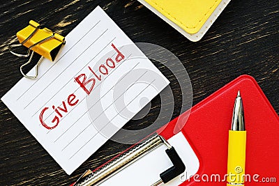 Business concept about Give Blood with sign on the page Stock Photo