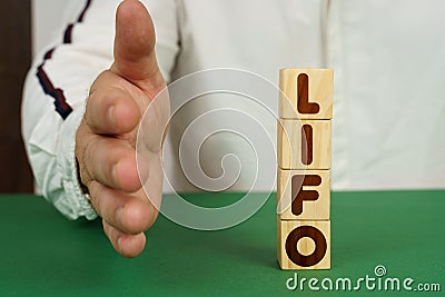 On a green surface, cubes with the inscription - LIFO Stock Photo