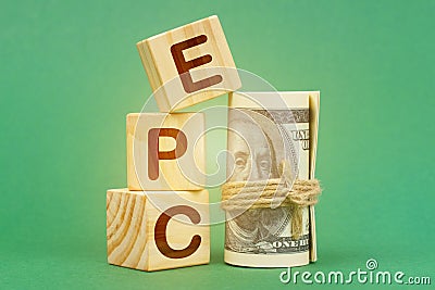 On a green surface, dollars and cubes with the inscription - EPC Stock Photo