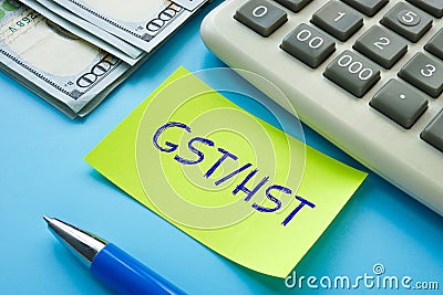 Business concept about GST/HST Goods Services Tax Harmonized Sales Tax with inscription on the sheet Stock Photo