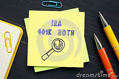 Business concept about IRA 401K ROTH Individual Retirement Accounts with sign on the piece of paper Stock Photo