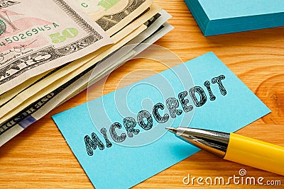 Business concept meaning MICROCREDIT with phrase on the piece of paper Stock Photo