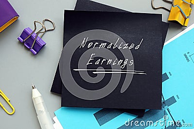 Business concept meaning Normalized Earnings with phrase on the piece of paper Stock Photo