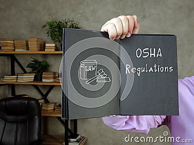 Business concept meaning OSHA Regulations with sign on the sheet Stock Photo