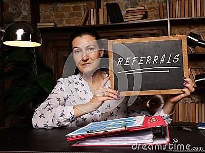 Business concept meaning REFERRALS with phrase on chalkboard Stock Photo