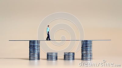 Business concept with a miniature person with a pile of coins. Stock Photo