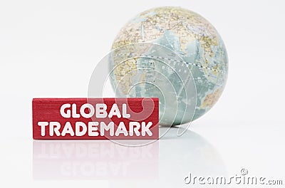 Near the globe is a red plaque with the inscription - Global Trademark Stock Photo