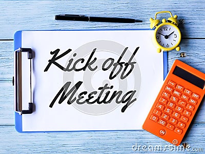 Phrase kick off meeting written on paper clipboard Stock Photo
