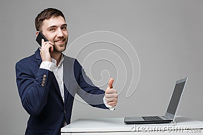 Business Concept - Portrait Handsome Business man showing thumb up and smiling confident face in front of his laptop Stock Photo