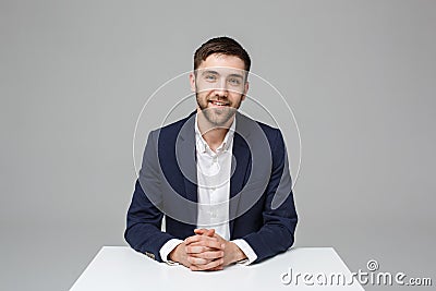 Business Concept - Portrait handsome happy handsome business man in suit smiling and siting in work office. White Stock Photo