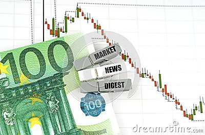 On the quote chart there are euros and clothespins with the inscription - Market News Digest Stock Photo