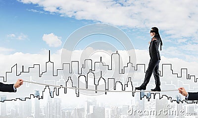 Business concept of risk support and assistance with man balancing on rope Stock Photo